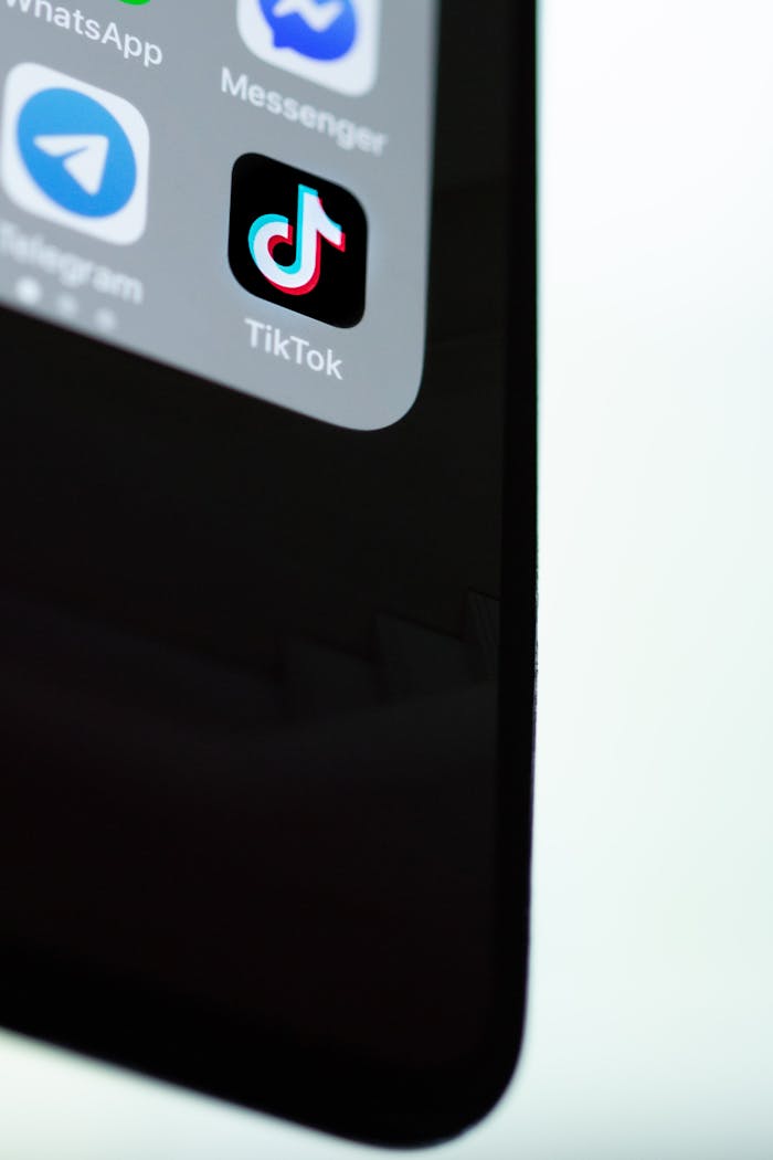 Detailed view of TikTok app icon on a modern smartphone screen, minimalist background.